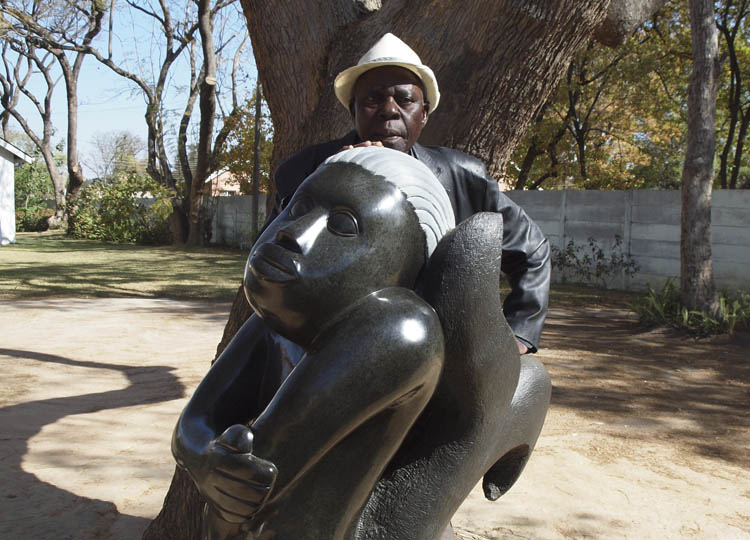Sylvester Mubayi with one of his sculptures
