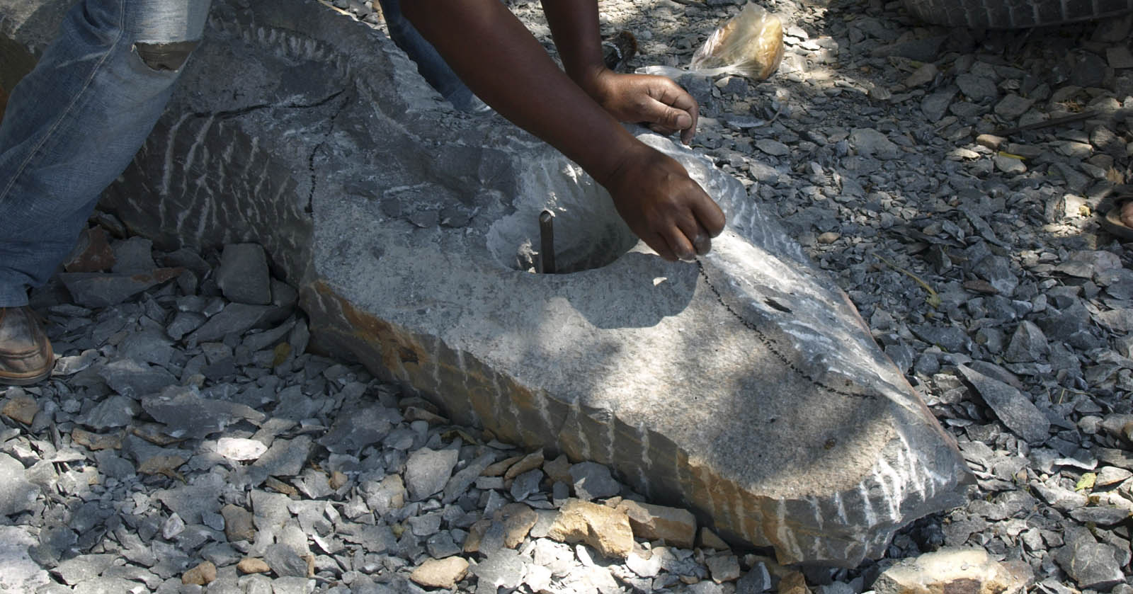 sketching with charcoal onto raw stone