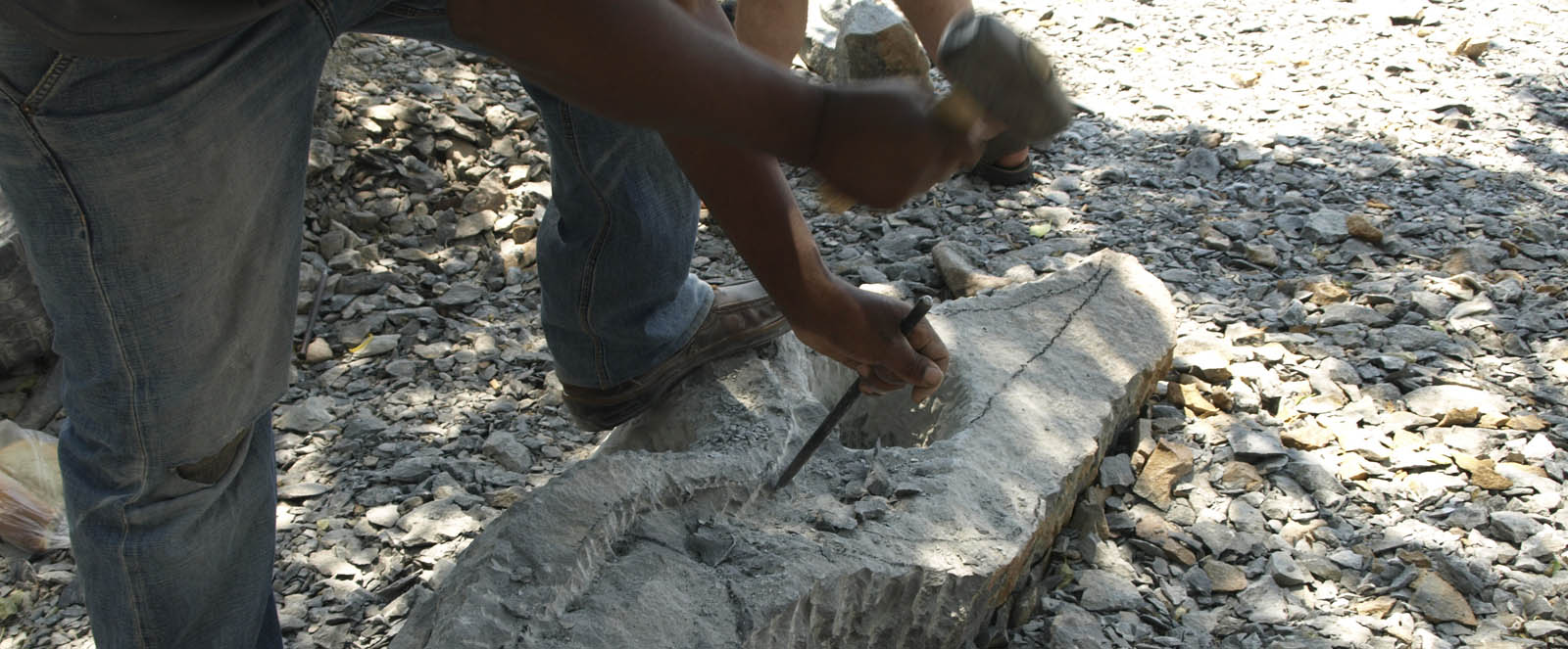 shaping the raw stone with a punch