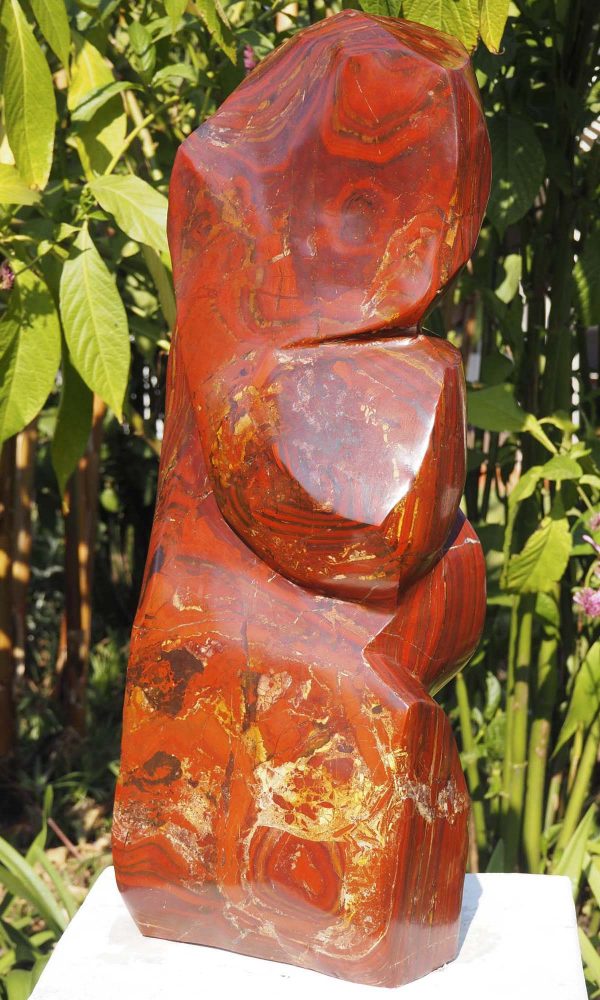 Birds sculpture red stone Tickling by Tago Tazvitya back
