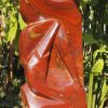 Birds sculpture red stone Tickling by Tago Tazvitya front left