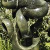 Abstract garden stone sculpture - Growing Force by Willard Bopoto front right