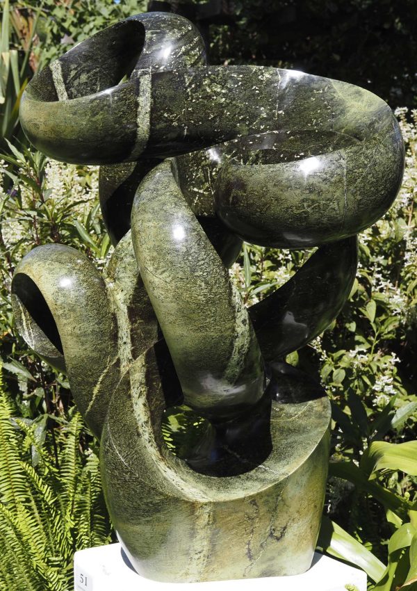 Abstract garden stone sculpture - Growing Force by Willard Bopoto front right