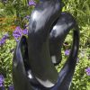 Abstract black stone sculpture - Opportunity by Tonderai Sowa back left
